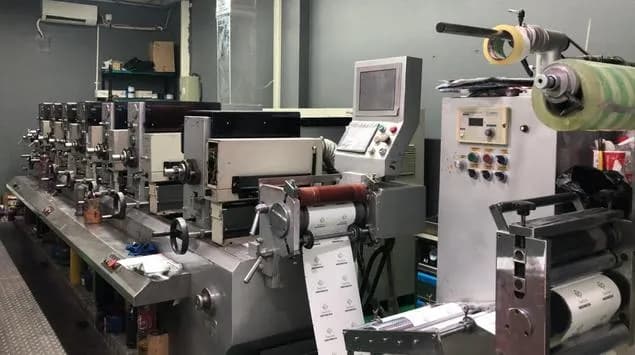 A multi-station label printing press on the factory floor