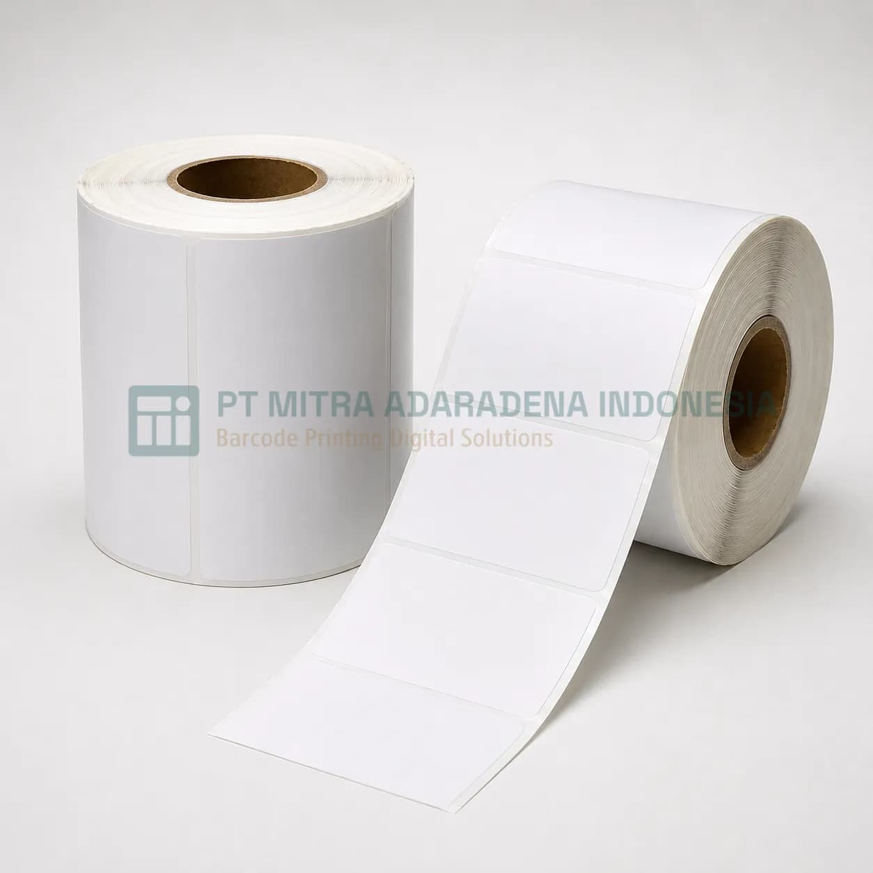 Two rolls of semicoated paper label stock, one unwound to show the die-cut labels