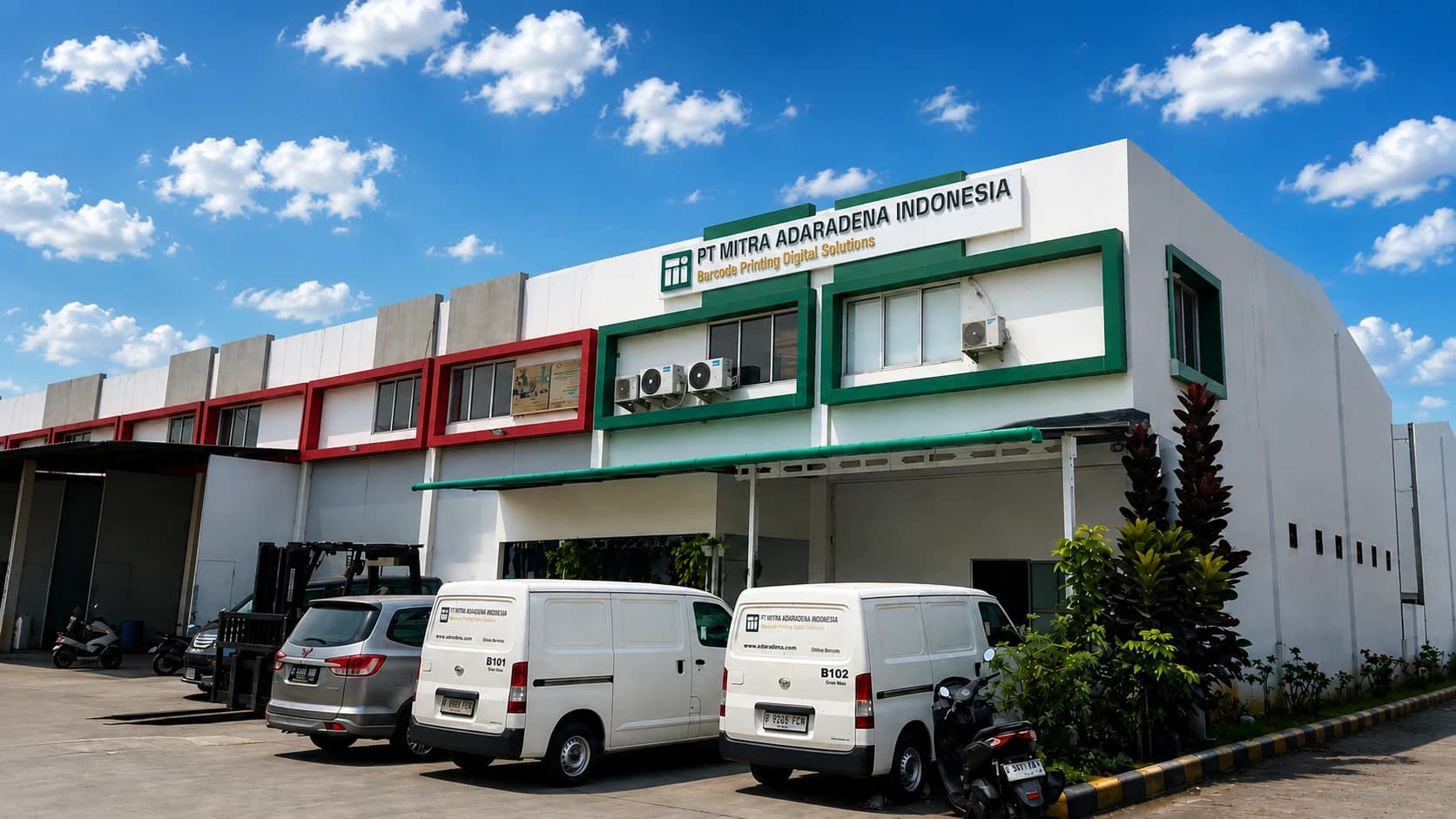 The PT Mitra Adaradena Indonesia plant in Tambun Selatan, its name board above the entrance and two company vans parked outside